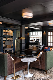 Harley channel-tufted armless sofa in Saloon Dark Brown leather and Martexin Olive waxed canvas at Nouveau Monde Wine Bar